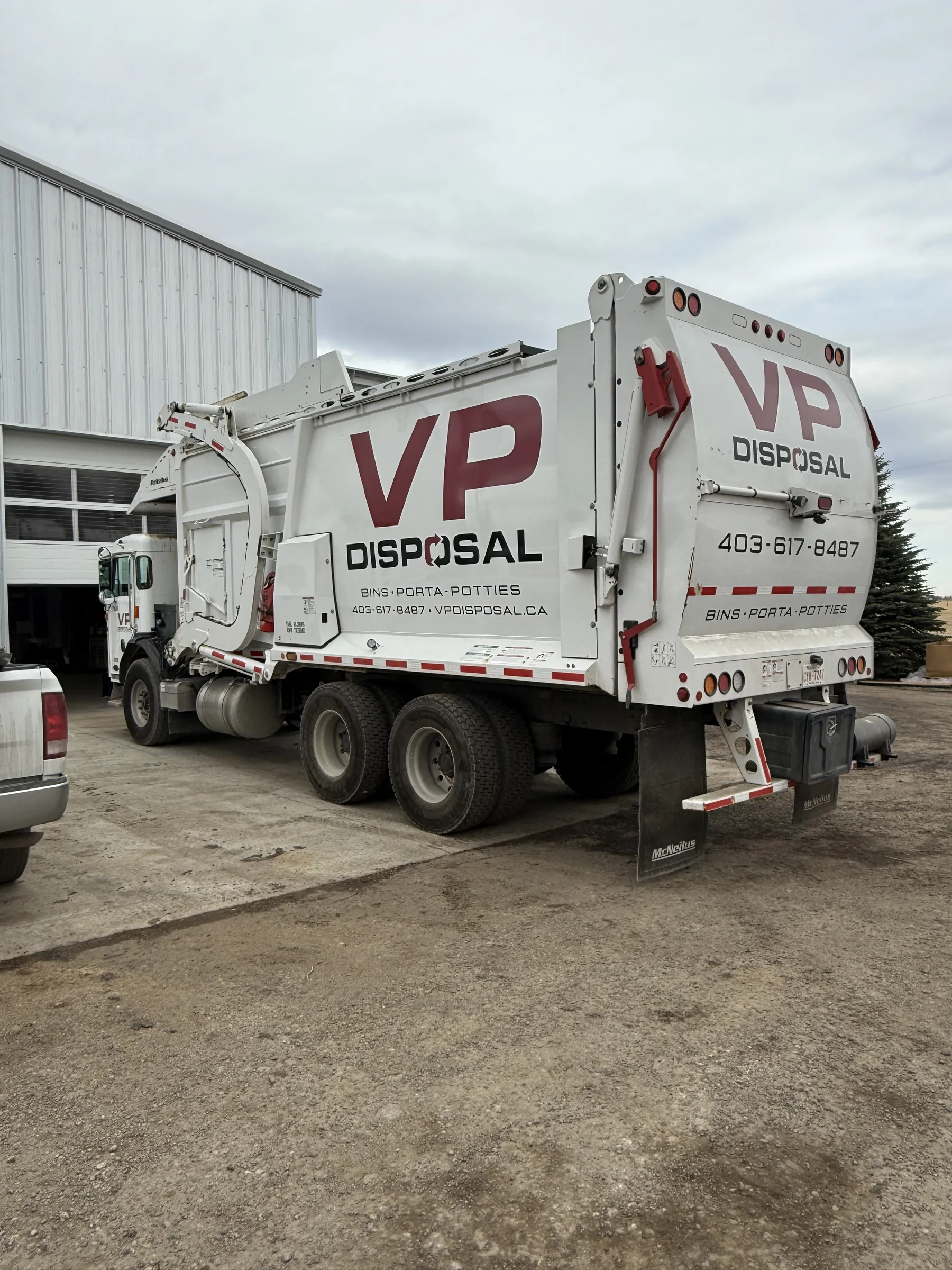 Rear view of a VP Disposal collection truck in the yard