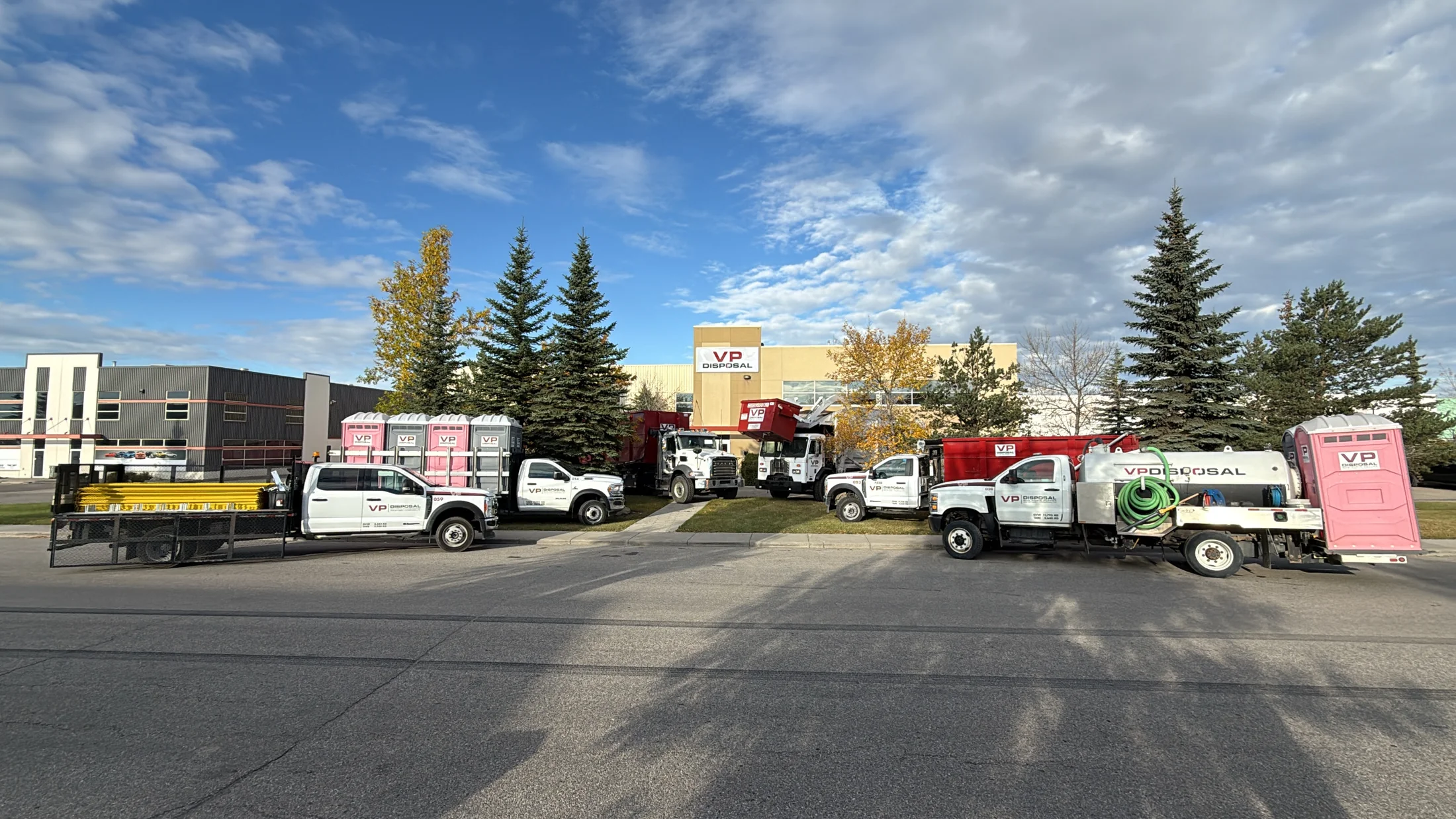 VP Disposal trucks, bins and portable toilets lined up outside the Calgary yard